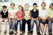 Children sitting on the bench smiling