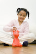 Girl putting coin into piggy bank