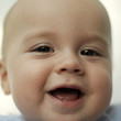 Baby boy smiling at the camera