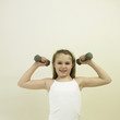 Little girl lifting dumbbell