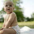 Baby boy sitting in the park