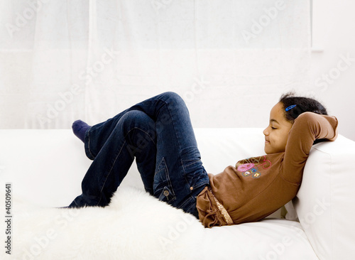 Photo: Girl crossing her legs while resting on the couch Girl crossing her legs while resting on the couch