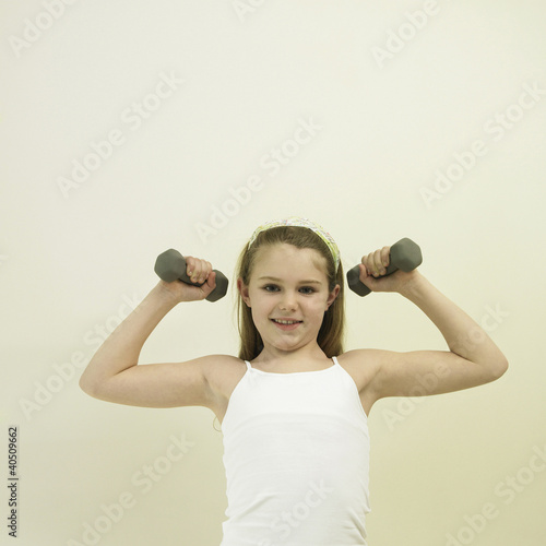 Photo: Little girl lifting dumbbell Little girl lifting dumbbell