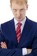 Portrait of an angry young business man in suit isolated over wh