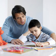 Father watching son doing homework