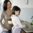 Mother and daughter washing the dishes together
