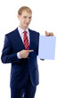 Happy smiling young business man showing blank signboard, isolat