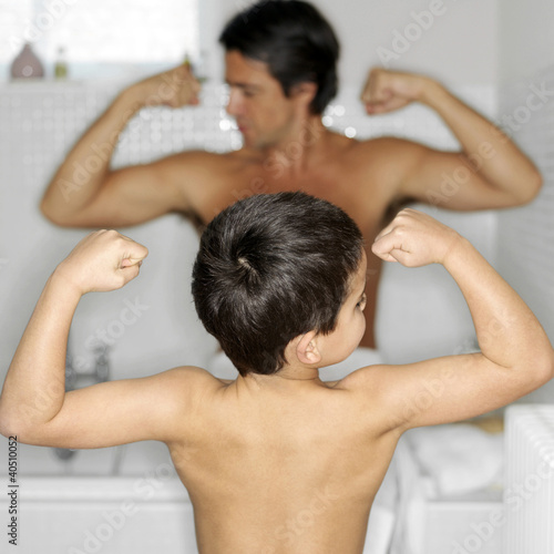 Photo: Father and son showing off their muscular arms Father and son showing off their muscular arms