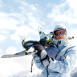 Woman in ski goggles holding snowboard