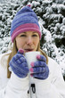 Woman drinking hot beverage, standing outdoor