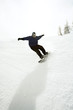 Snowboarder riding downhill