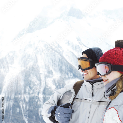 Photo: Couple in warm clothing and ski goggles Couple in warm clothing and ski goggles