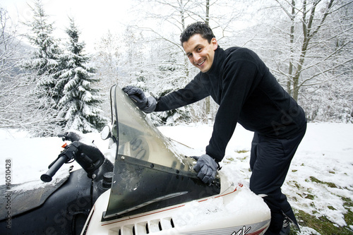 Photo: Man riding on snowmobile Man riding on snowmobile