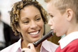 Woman teaching boy to play recorder