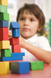 Boy playing with wooden blocks