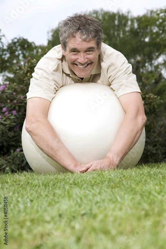 Photo: Senior man resting on fitness ball Senior man resting on fitness ball