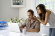 Woman watching man work in a home office