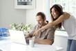 Woman watching man work in a home office