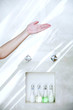 Hand testing water from shower