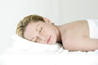 Woman lying forward on massage table with her eyes closed