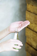 Woman pouring bath liquid onto palm