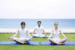 Men and woman pratising yoga