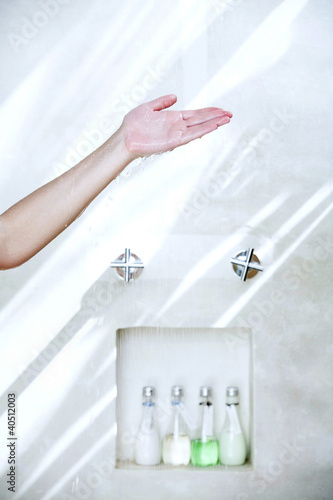 Photo: Hand testing water from shower Hand testing water from shower