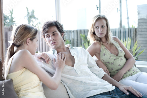 Photo: Woman touching man, another woman watching Woman touching man, another woman watching
