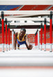 Man crawling under the hurdles
