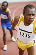 Men passing baton in relay race