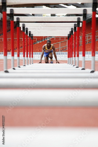 Photo: Man getting ready to jump hurdles Man getting ready to jump hurdles