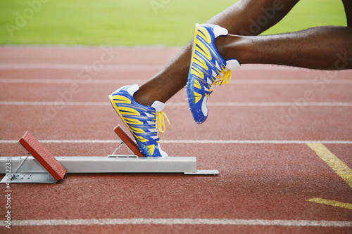 Photo: Man leaving starting block Man leaving starting block
