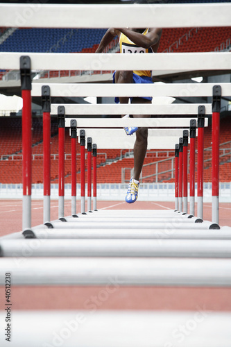 Photo: Man jumping over hurdles Man jumping over hurdles