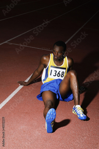 Foto: Man sitting on the running track Man sitting on the running track
