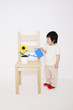 Boy watering a potted plant