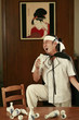 Drunk man singing into sake bottle