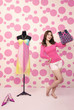 Dress on mannequin with high heels and a woman holding a paperbag