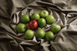 Red apple amongst green apples