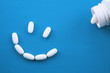 Pills being arranged into a smiley face