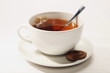 A cup of tea with biscuit at the side