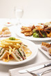 Photo: Club sandwich, fried yam puffs, fried puff pastries, and bruschetta served with chicken wings Club sandwich, fried yam puffs, fried puff pastries, and bruschetta served with chicken wings