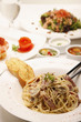Spaghetti carbonara and salad in the background