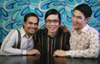 Three men smiling at the camera