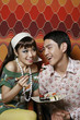 Man and woman enjoying a plate of sushi
