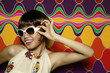 Woman smiling while adjusting her sunglasses