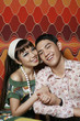 Man and woman smiling while holding hands