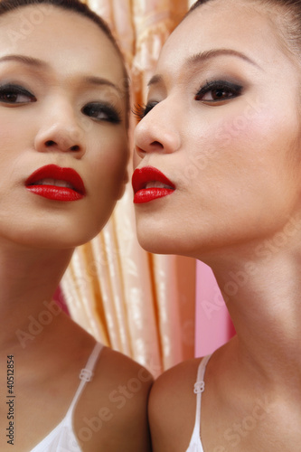 Photo: Woman posing close to the mirror Woman posing close to the mirror
