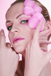 Woman with flower petals decorating her face