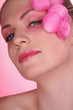 Woman with flower petals decorating her face