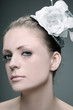 Woman with flower and hat decorating her hair